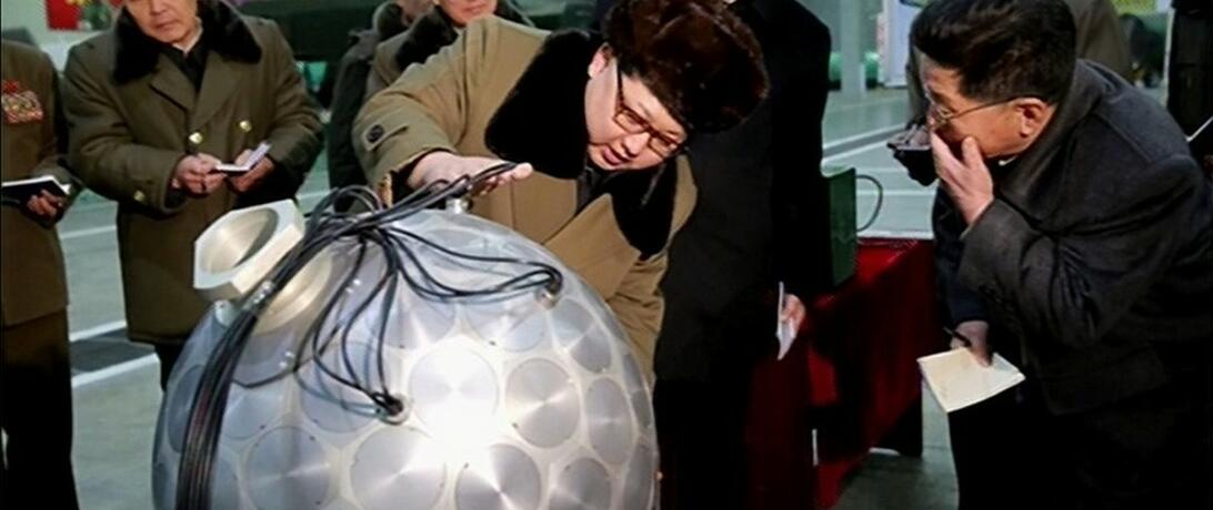 Image of Kim Jong Un next to bomb model